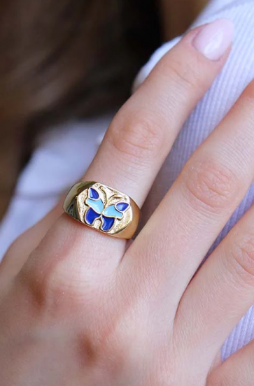 Elegant ring with butterfly motif, blue color.